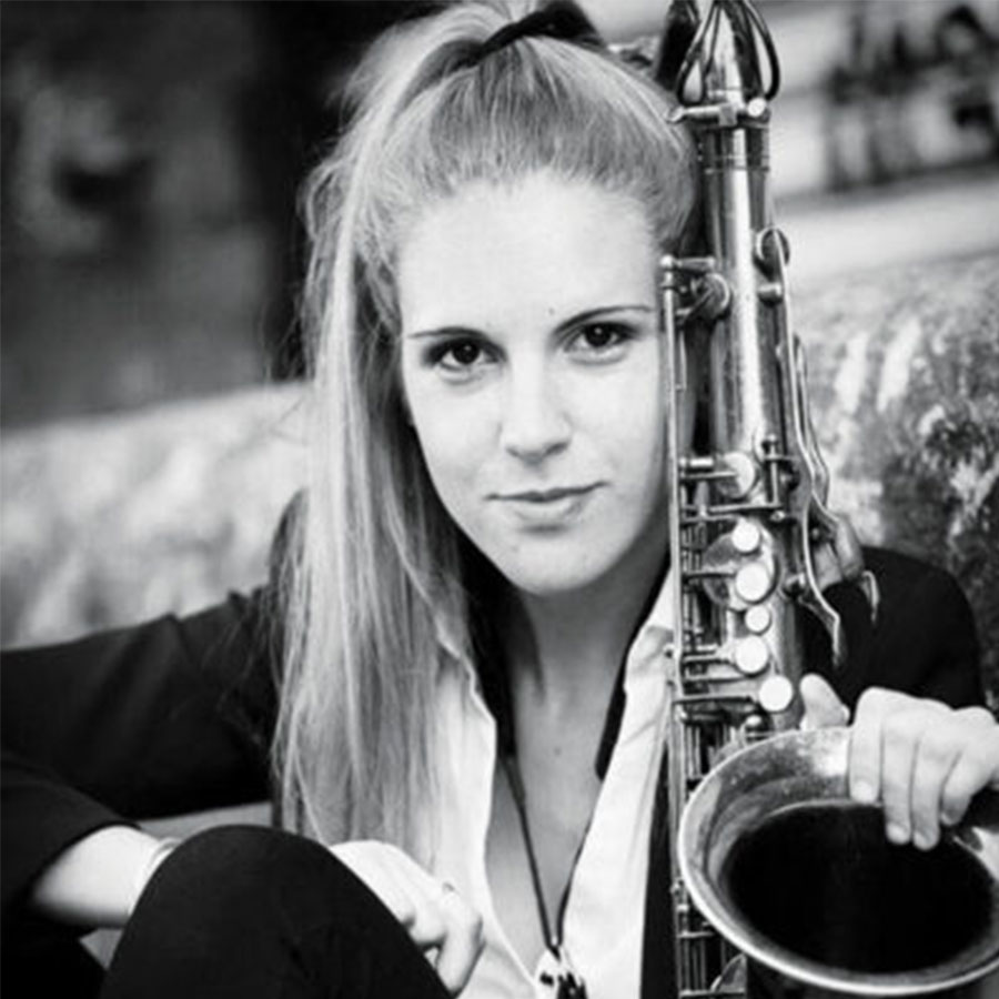 Headshot of Julieta Eugenio with her saxophone