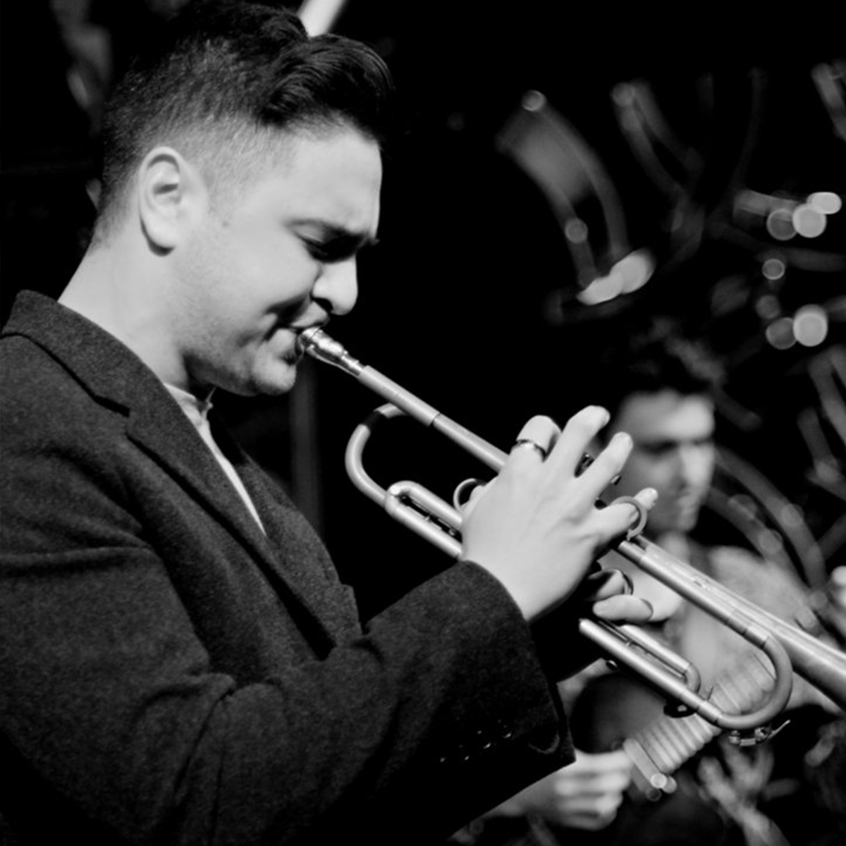 Headshot of James Sarno playing trumpet