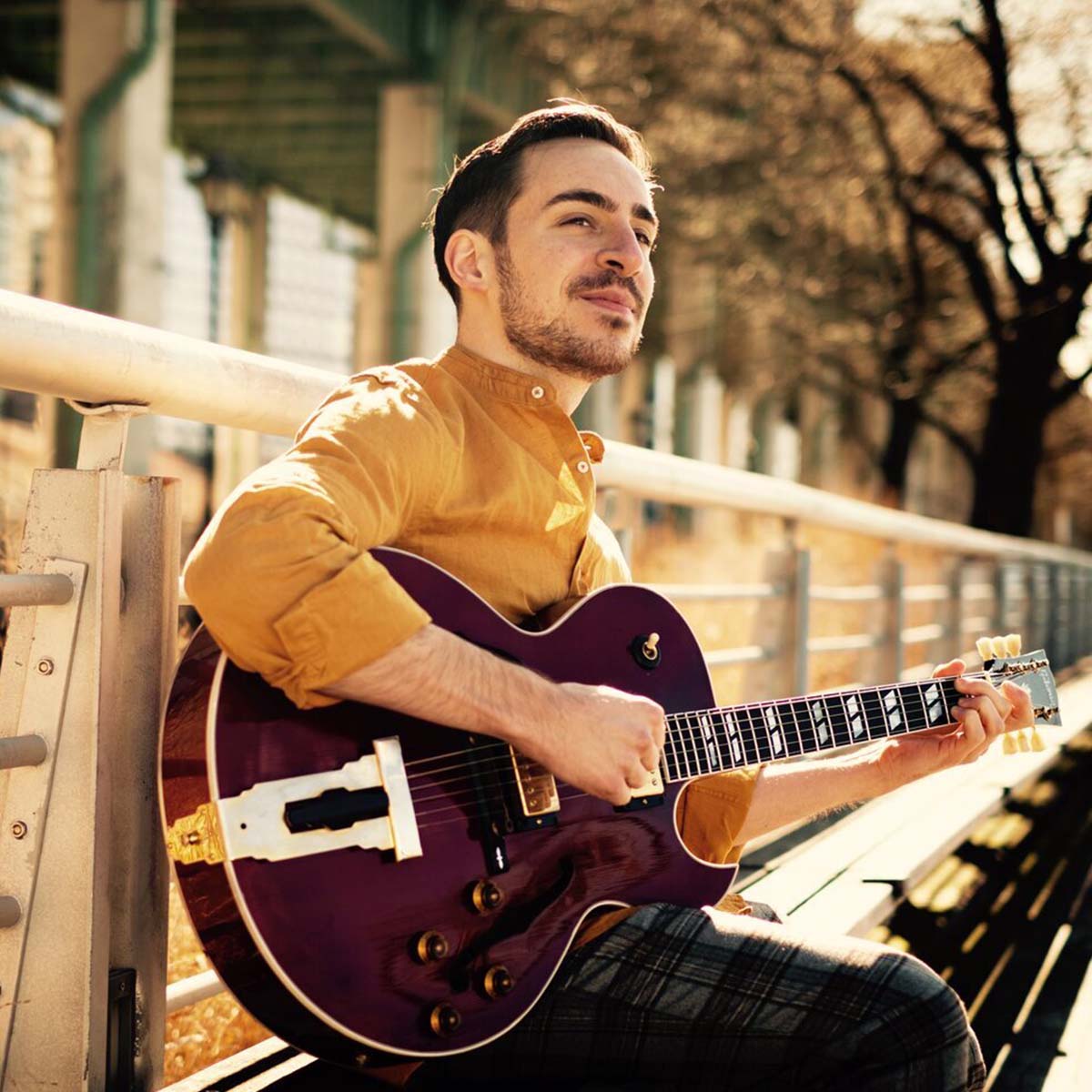 Headshot of Tony Davis with his guitar