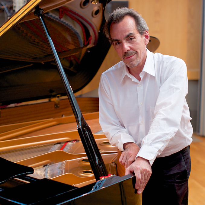 Lee Musiker leaning on a grand piano