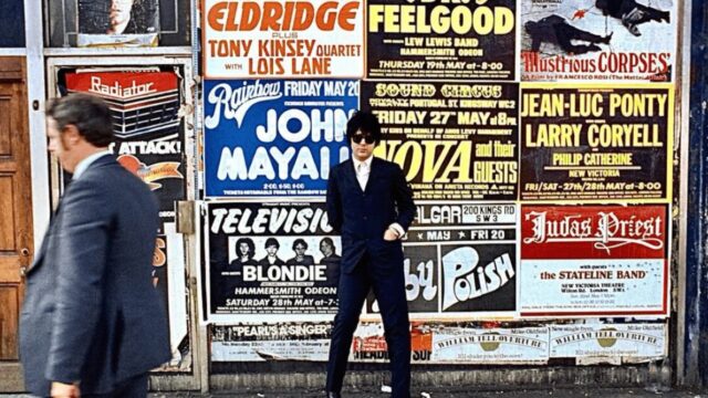 Clem Burke On Kings Road In London Next To A Television/Blondie Poster.