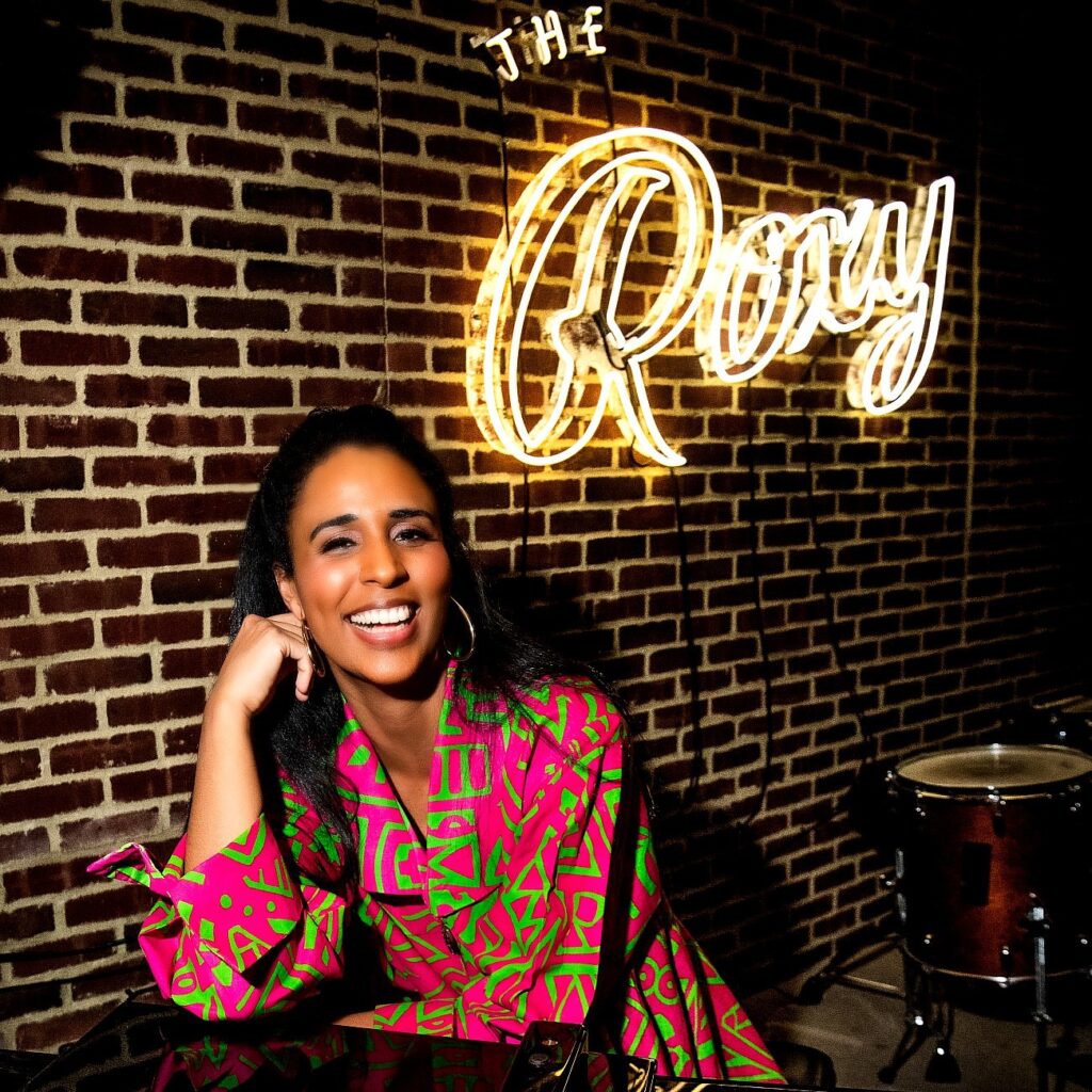 Camila Cortina sitting at the piano onstage at Roxy Bar in Roxy Hotel.