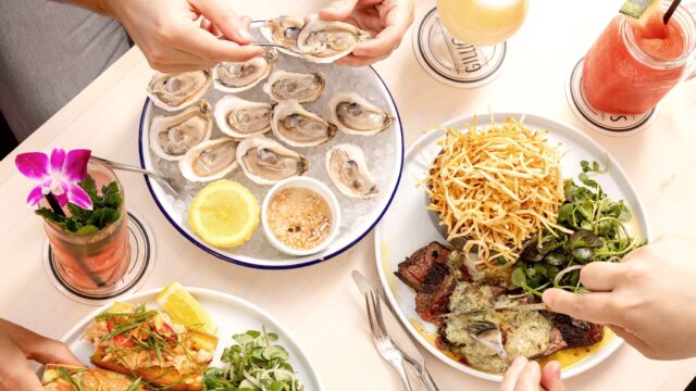 Table with Oysters and Steak at Gilligan's Outdoor Restaurant in SoHo, NY.