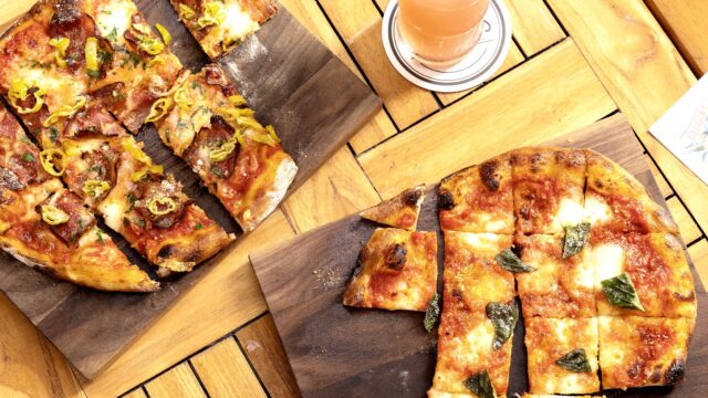 Pizzas on wood boards at Gilligan's in NYC.