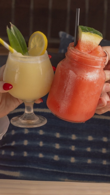 Two frozen drinks being toasted.