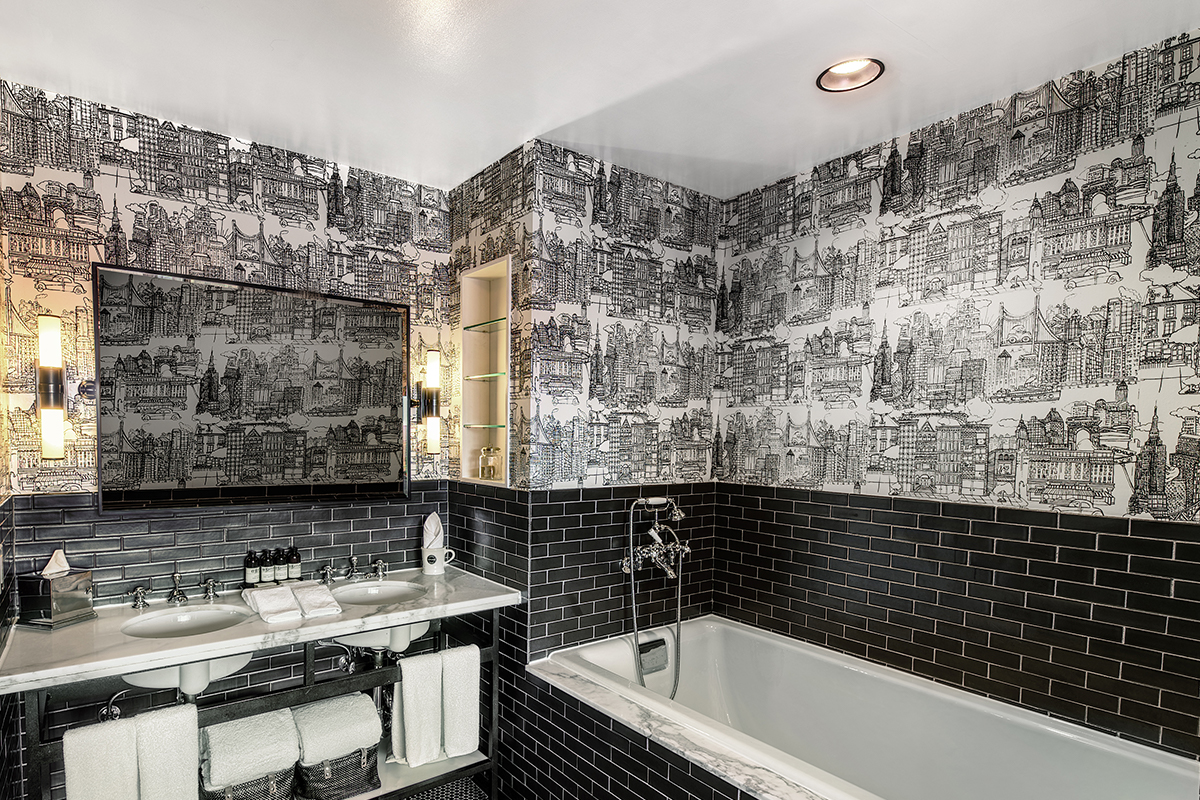 the grand suite bathroom with a tub and two sinks