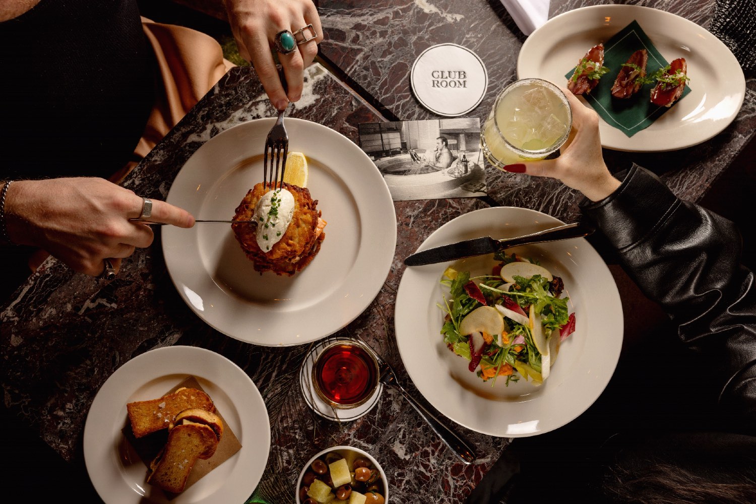 Patrons sampling various dishes at Club Room.