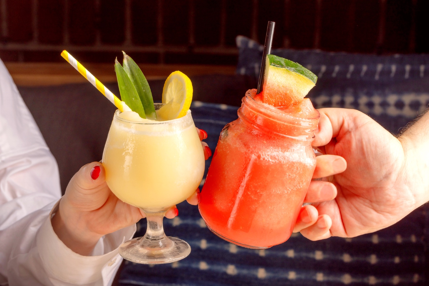 Two frozen cocktails being toasted at Gilligan's outdoor restaurant and bar in SoHo, NY.