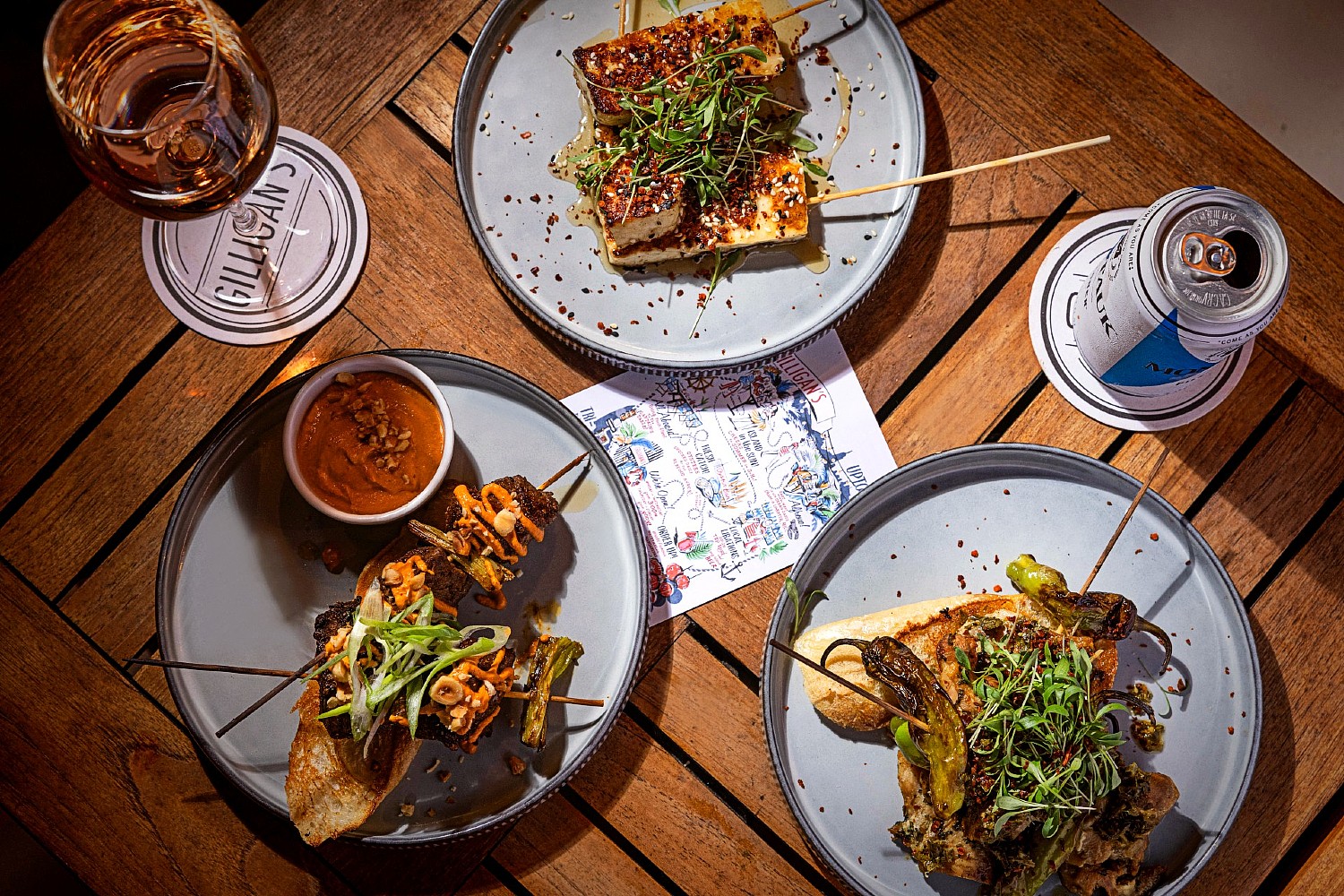 Overhead view of plated entrees at Gilligan's outdoor restaurant in SoHo.