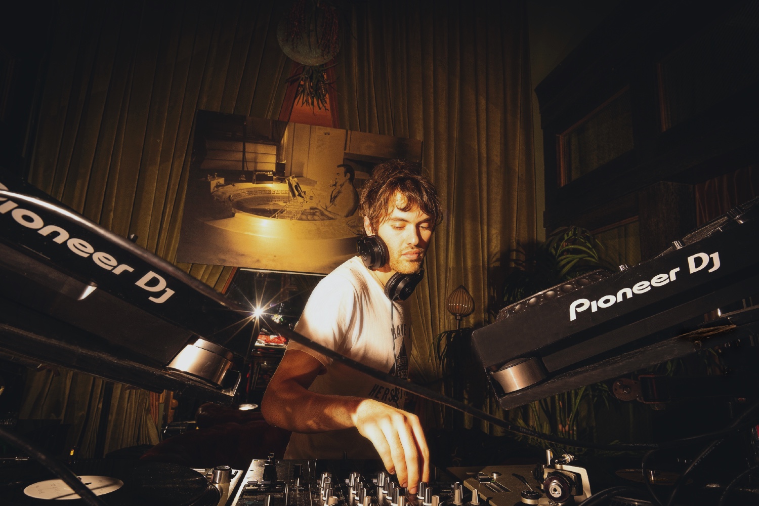 Deejay playing live music on the stage of Club Room.