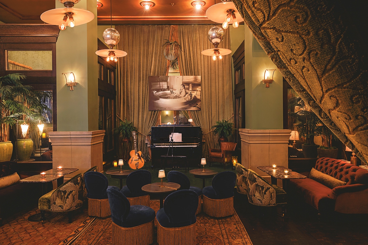 Club Room parlor with seating and stage for live music.