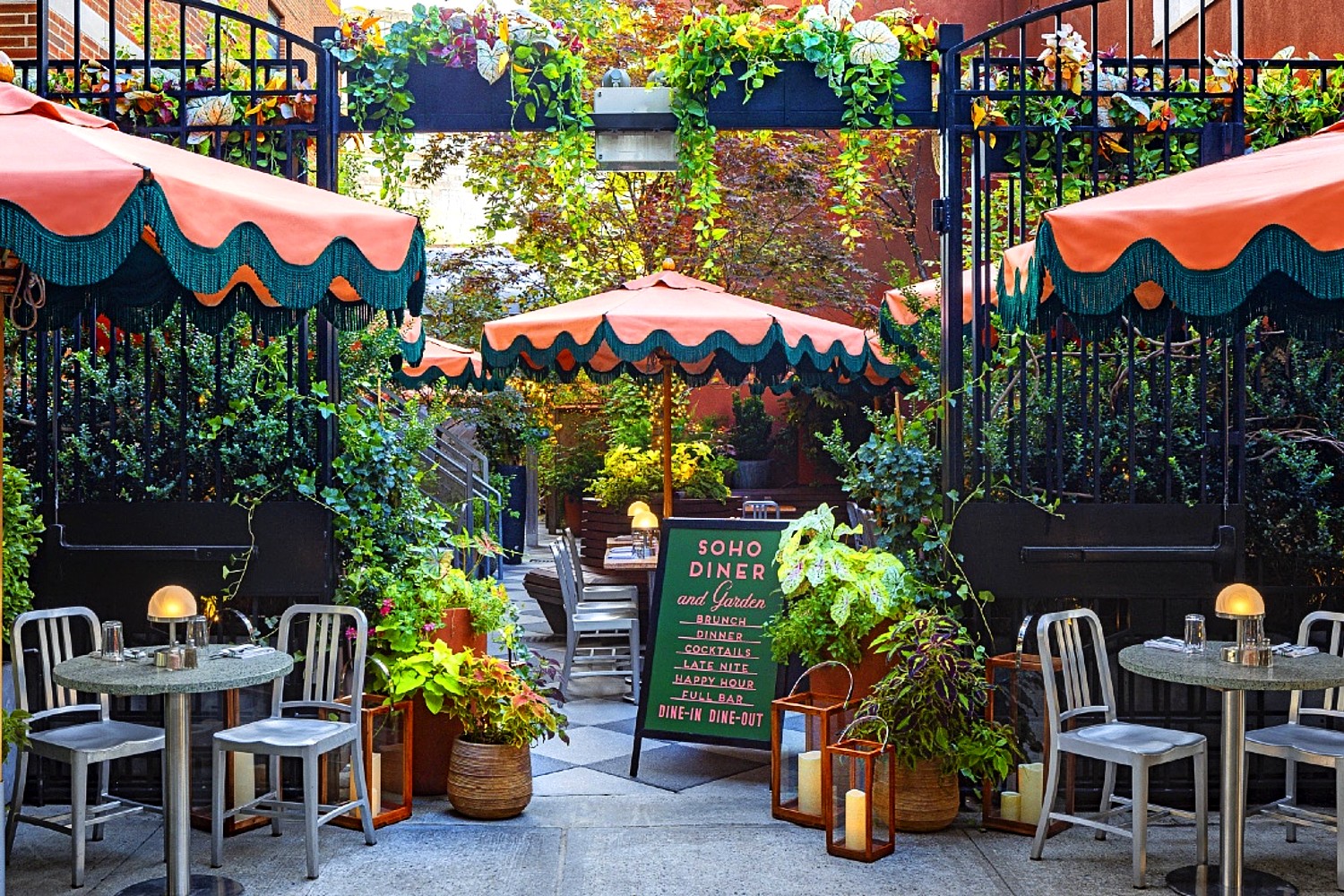 Entrance to Soho Grand Hotel’s outdoor garden featuring lush greenery and inviting seating in the heart of downtown New York City.
