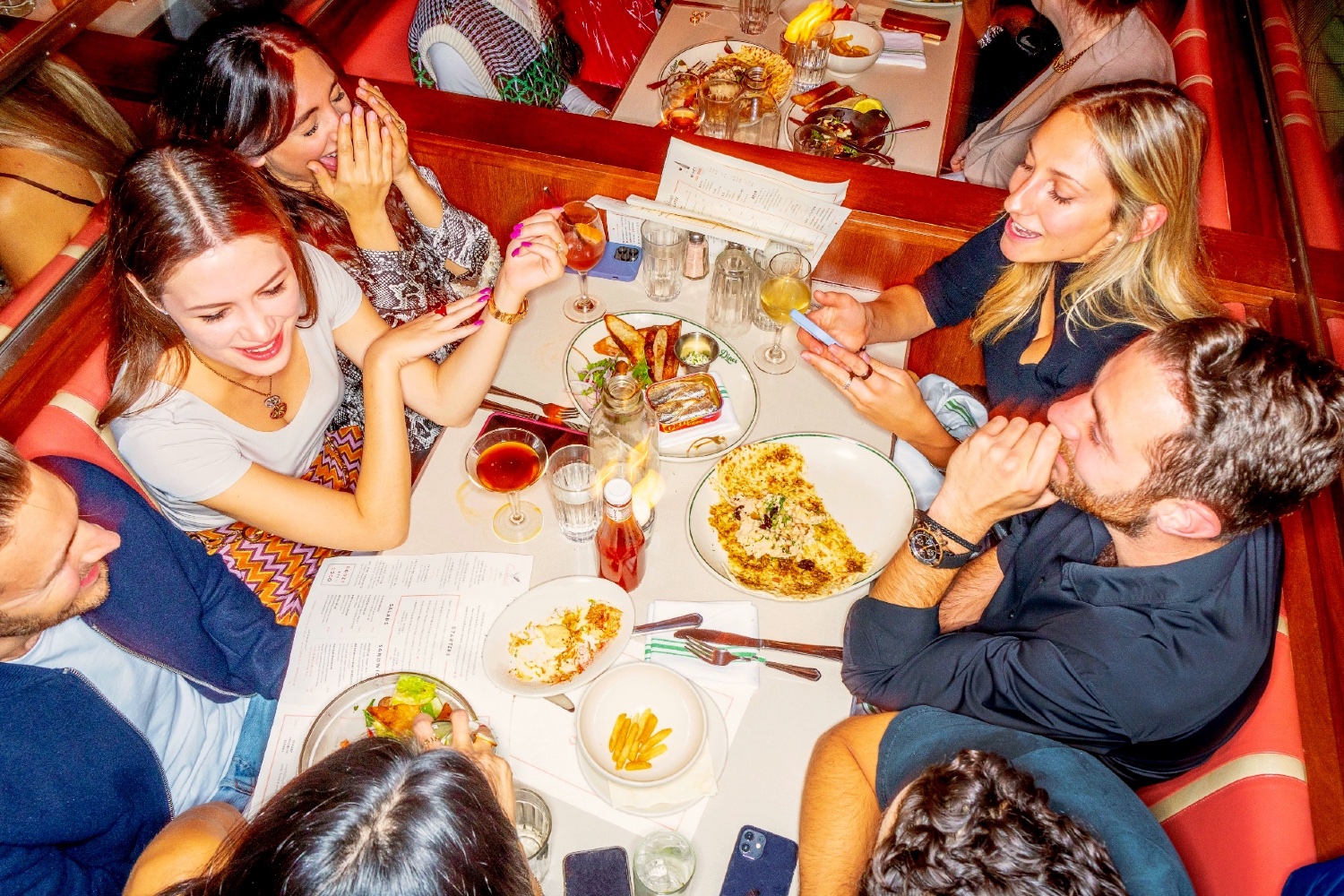 Guests eating dinner in a booth at Soho Diner.