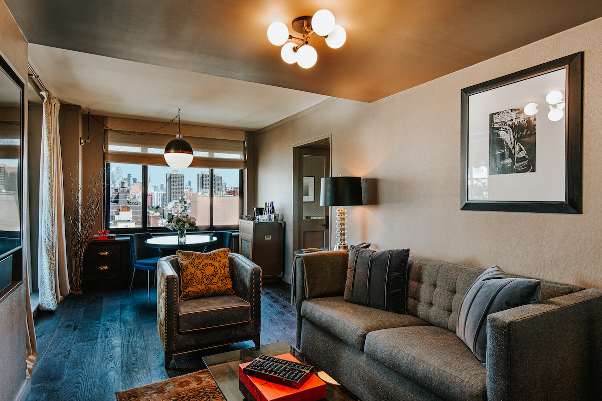 terrace suite living toom with a couch, coffee table and dining table