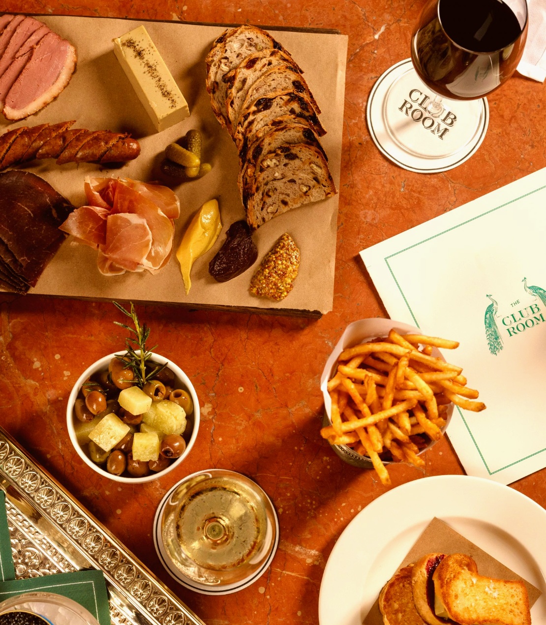 Appetizers and cocktails set on an orange marble table at Club Room.