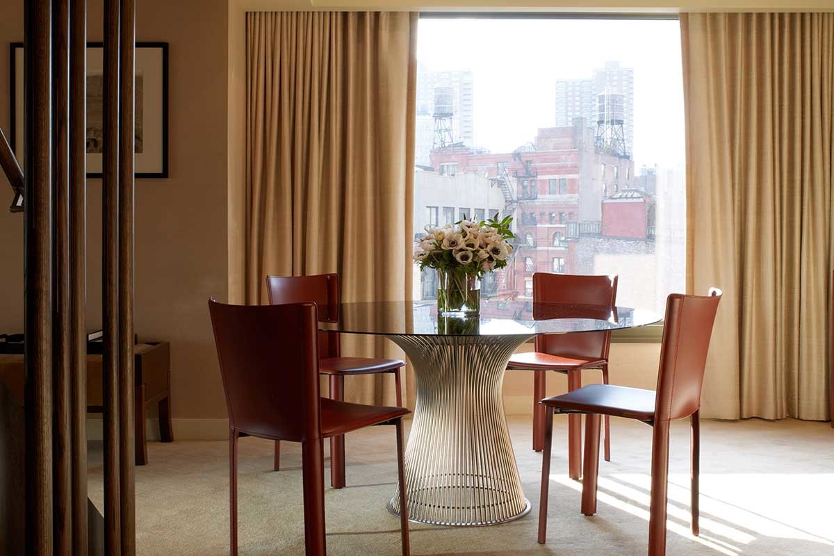 Roxy Penthouse dining room table with a flower arrangement on the tabletop