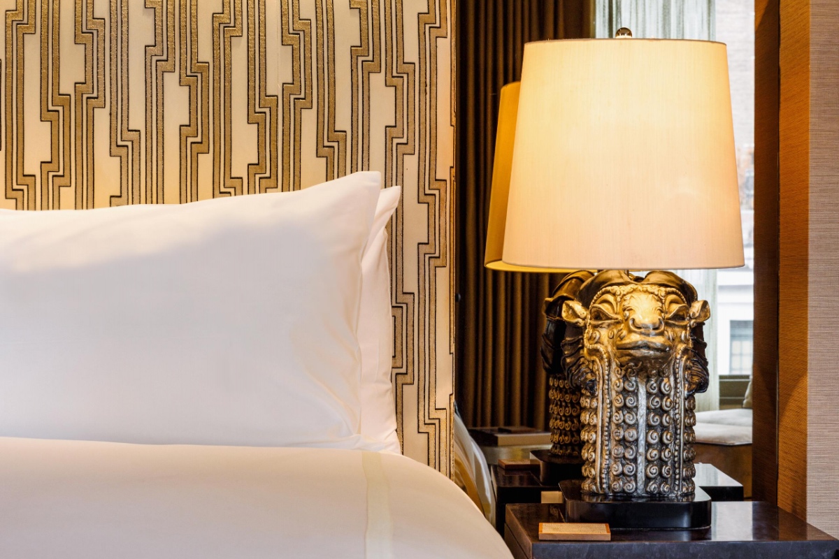 Detail of headboard, pillow and bedside lamp.