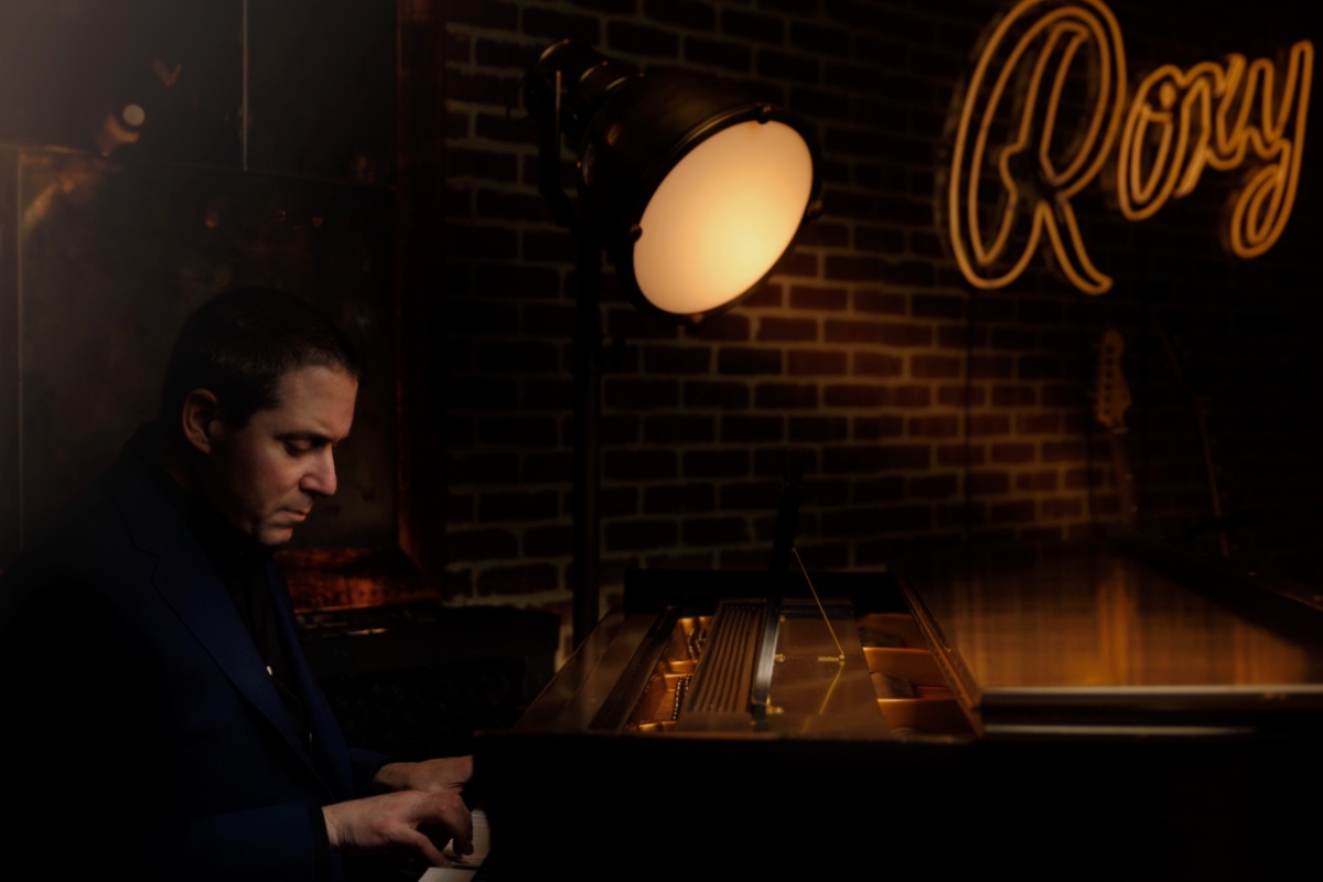 Man playing piano on the stage at Roxy Bar.