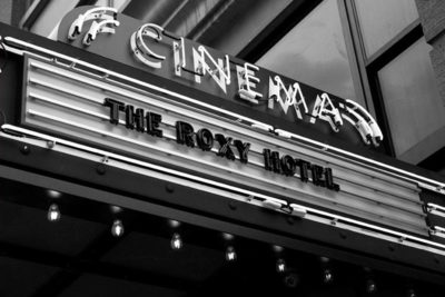 marquee for the roxy cinema lit up by neon lights