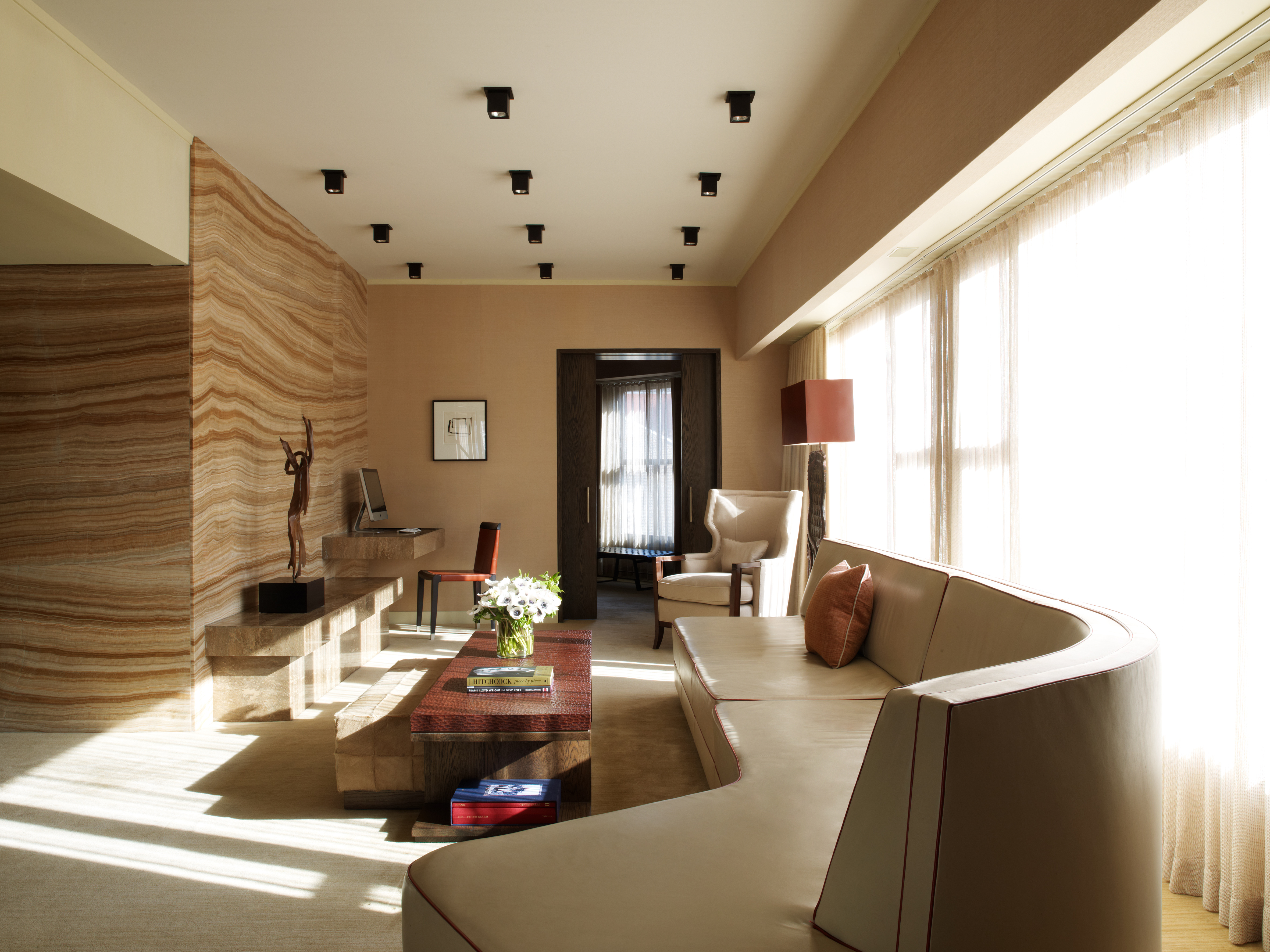 The Roxy Penthouse living room with a long beige modern couch and carefully curated design details