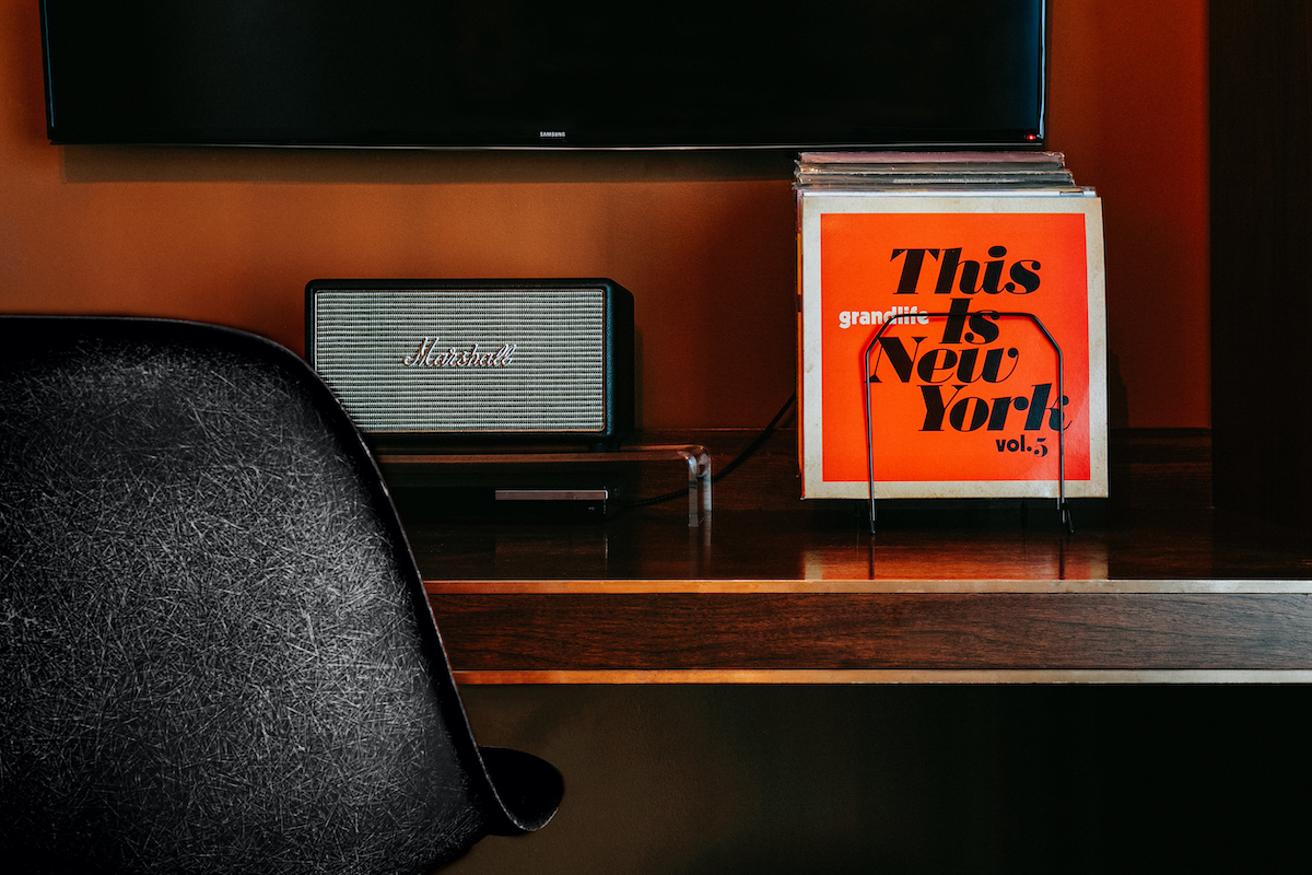 detail shot of the bedside table in the loft suite. There are records and a marshall speaker and turntable