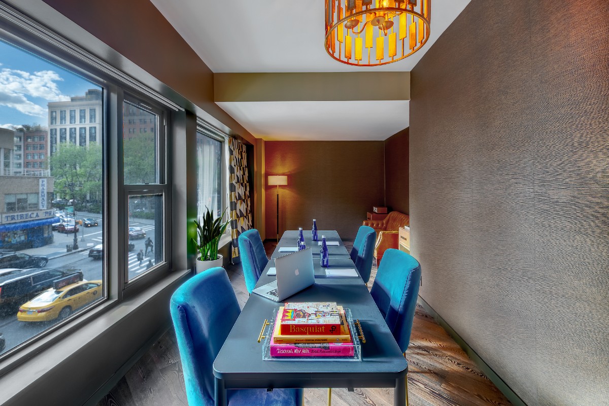 Workroom with work desk and expanded windows.