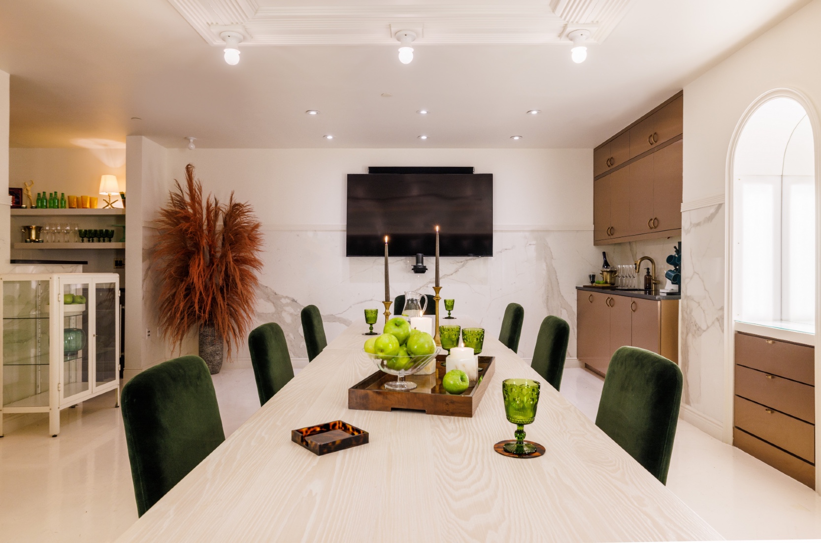 Green Room meeting space with board room table and tv at Roxy Hotel.
