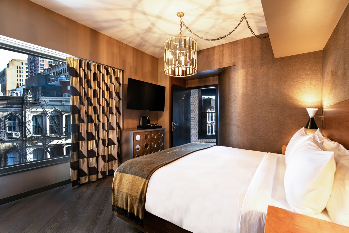 Guest Room King bed facing the window and tv looking out to buildings in TriBeCa, NY.