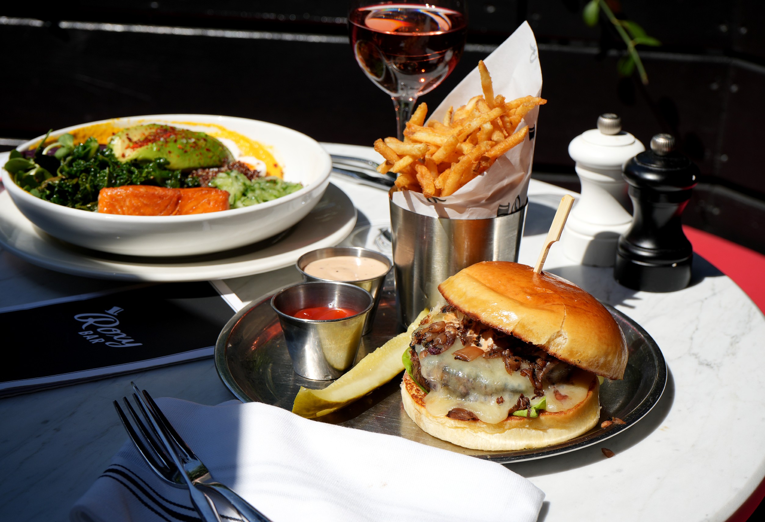Roxy Burger and Fries on an outdoor table at Roxy Cafe.