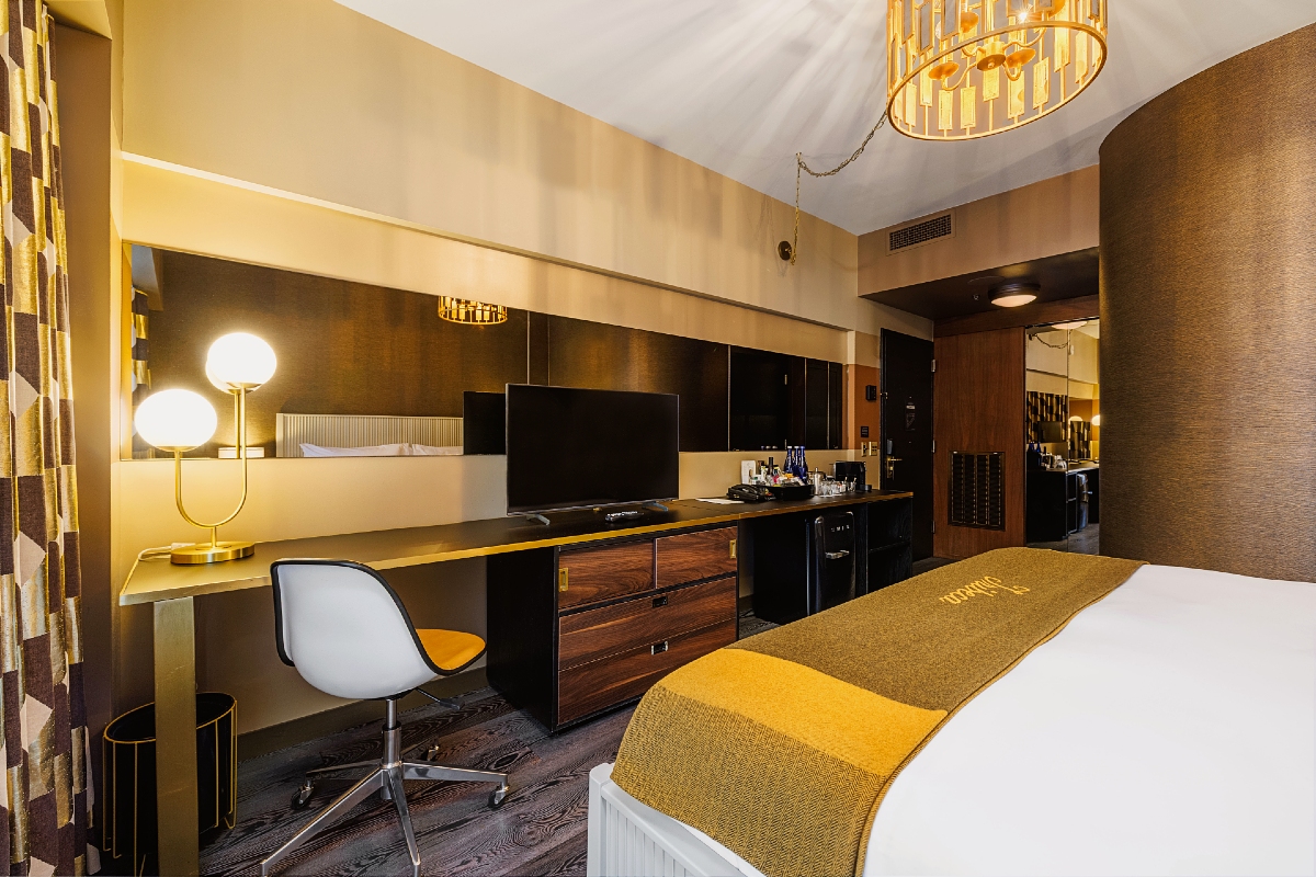 View of desk, television and mirror in a guest room at The Roxy Hotel