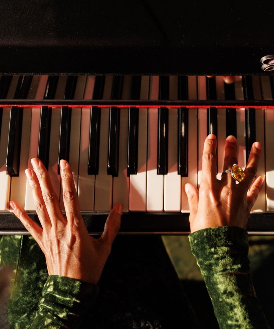 Closeup of woman's hands playing the electric piano.
