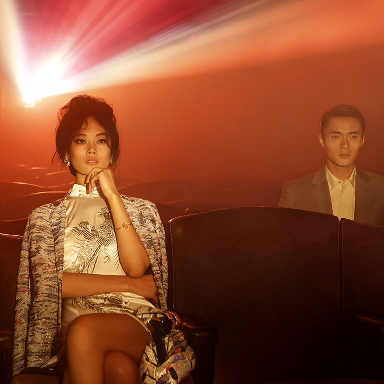 an editorial image of a man and woman in beautiful clothes sitting and enjoying a screening at the roxy cinema new york