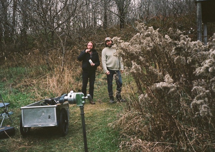 Two men standing in the woods