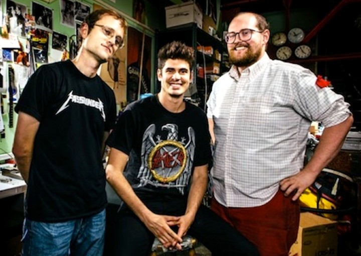 A trio of men standing